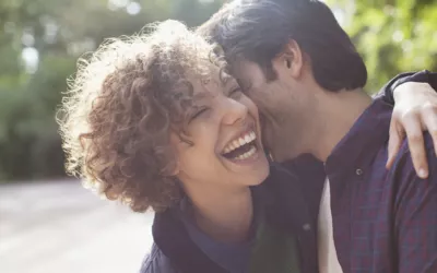 Close up laughing couple hugging