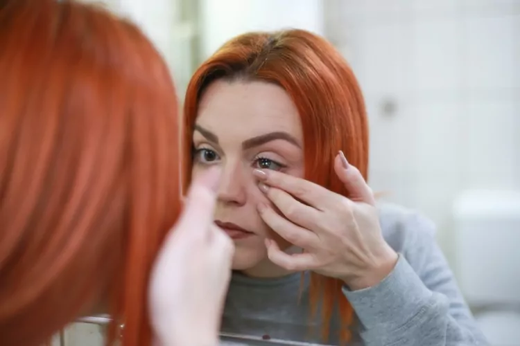 A woman putting in a contact lens