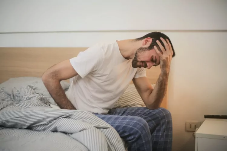 Man holding his head with a headache